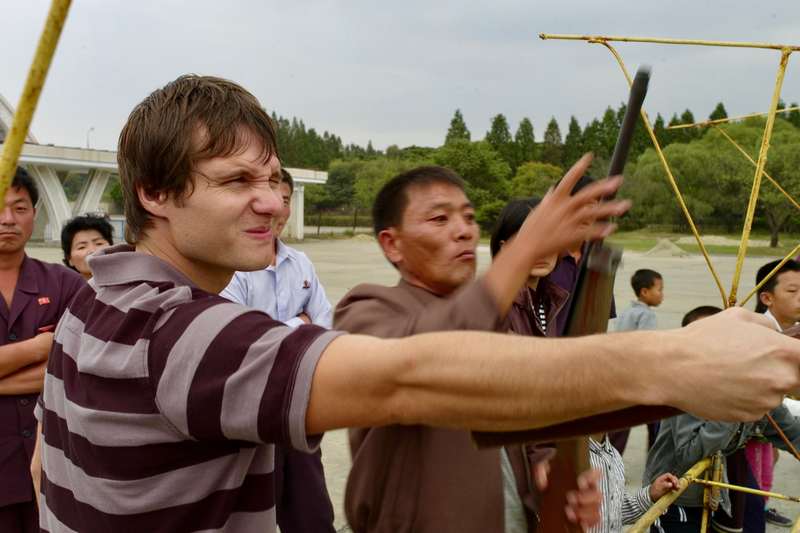 Justin locked in a tense shooting match with a rather tipsy local